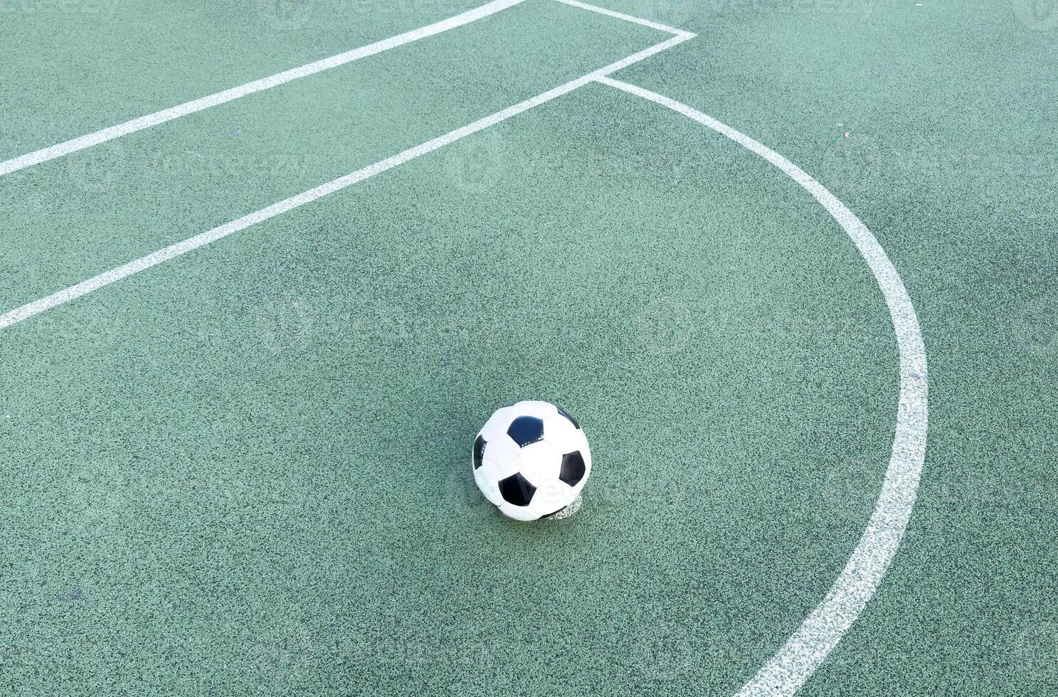 The ball in grass. The sideline. Fresh green grass. Black and white ball. photo