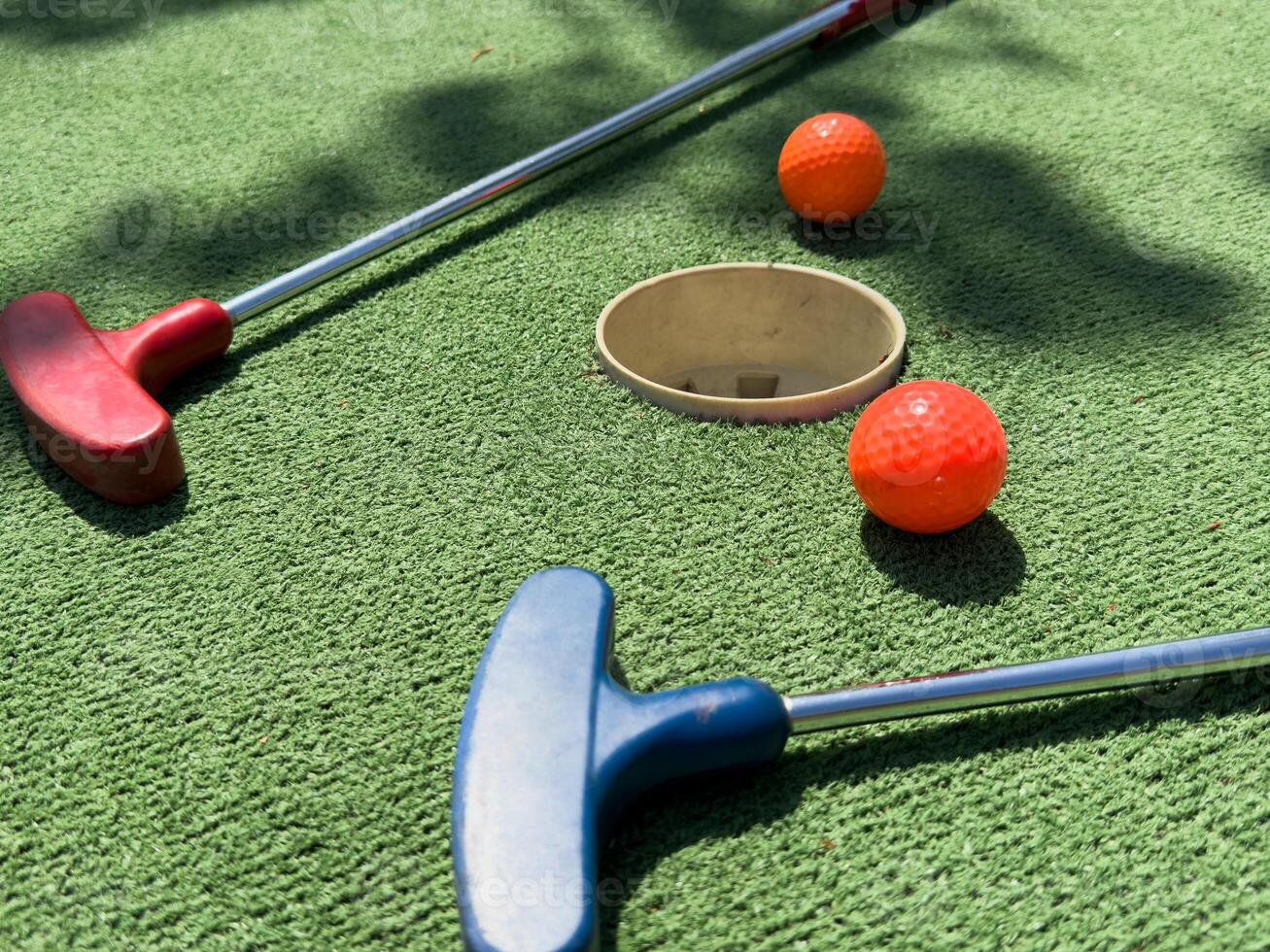 Closeup of player play mini golf with ball photo