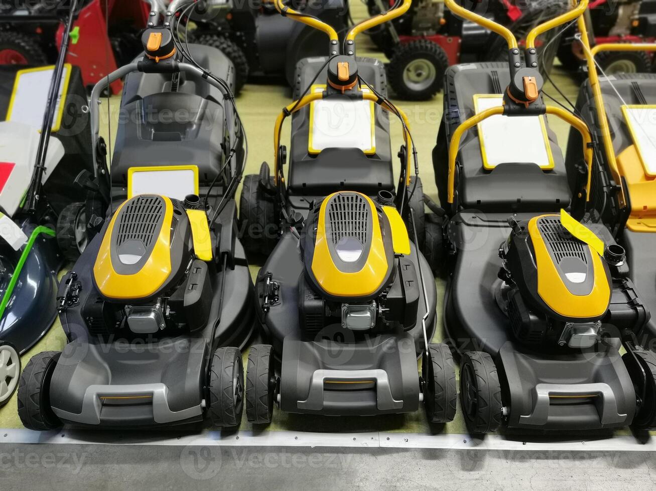Lawn mowers are sold in the shop. Garden equipment in stock in the store. photo