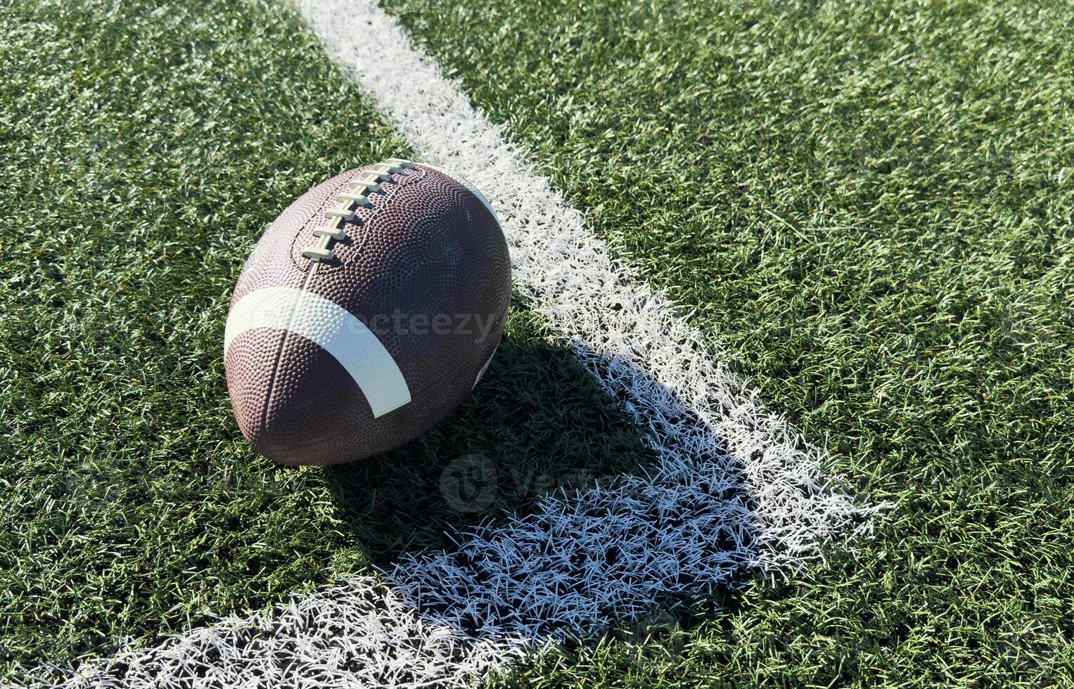 Pro American Football on the Field Close Up with Yard Lines Beyond photo