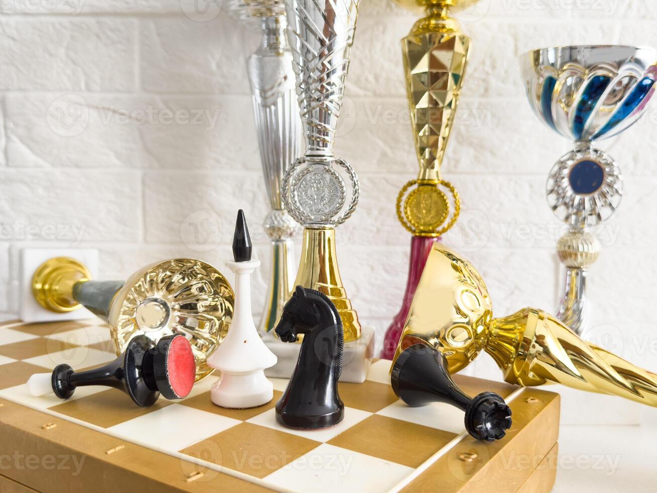 trophies for the winners and chess pieces on the chessboard photo
