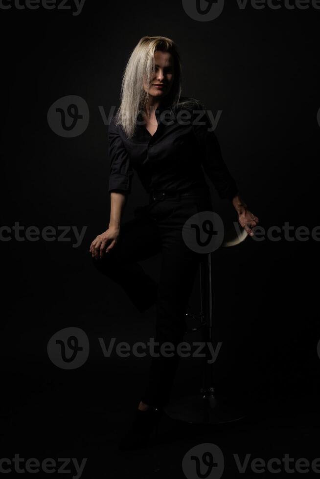 woman in black on a black background photo