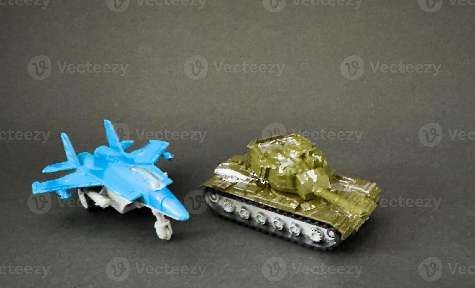 Toy fighter Plane and a toy tank photo