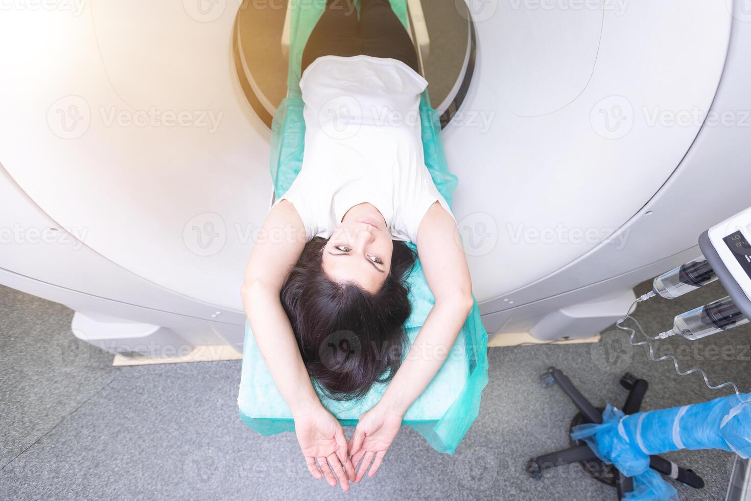 Radiologist with a female patient in the room of computed tomography. photo