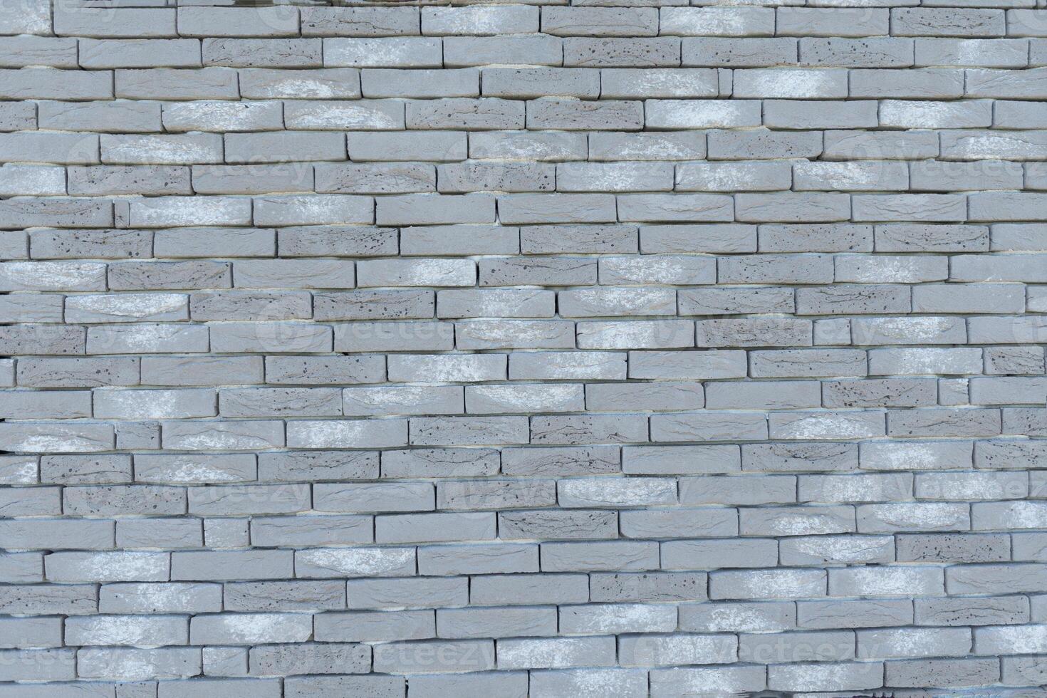 Gray textured brick wall, long and narrow modern bricks, horizontal decorative masonry, Textured stone background, brickwork outside new building, photo