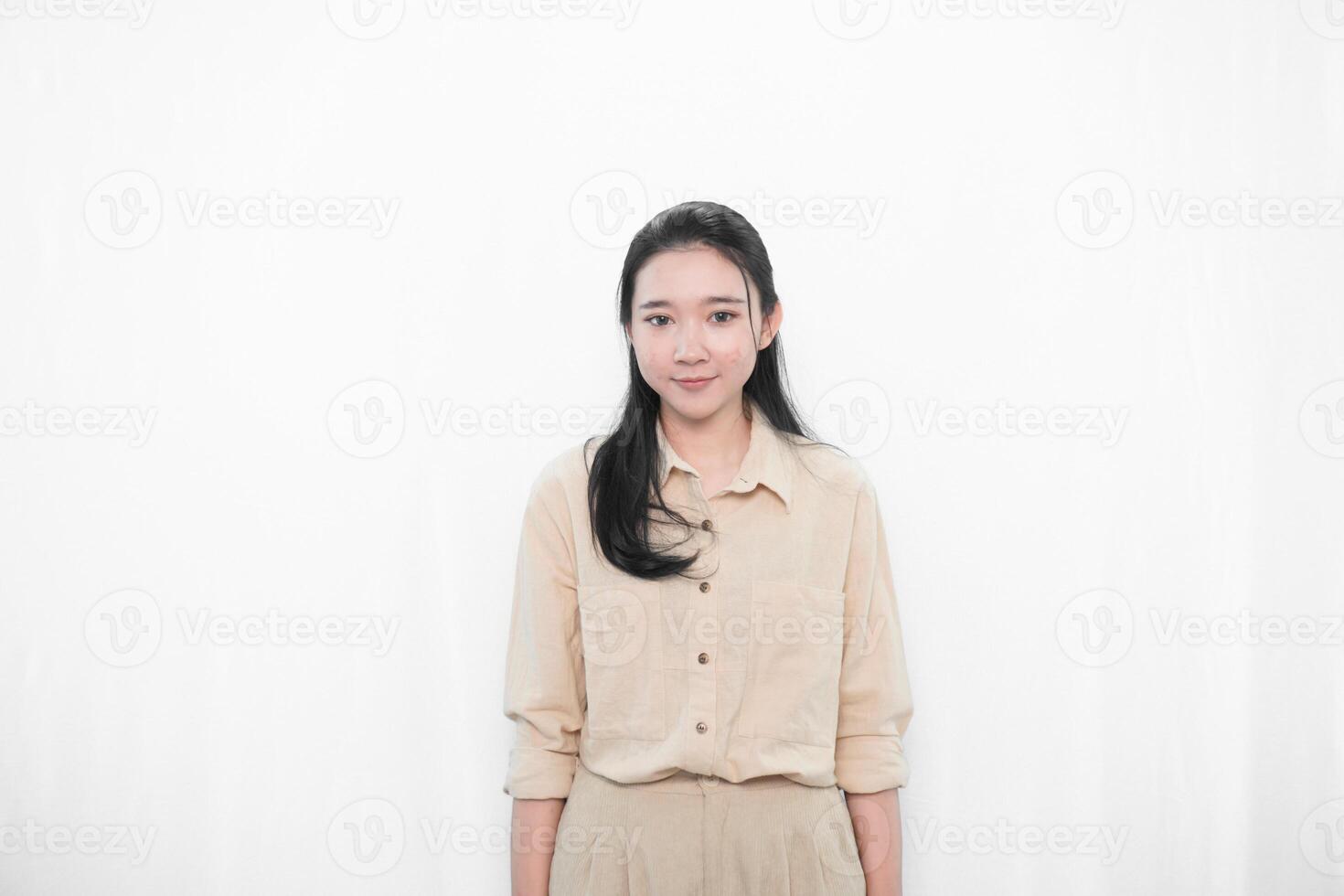 Expression of Indonesian Asian model woman in white dress smiling and standing straight photo