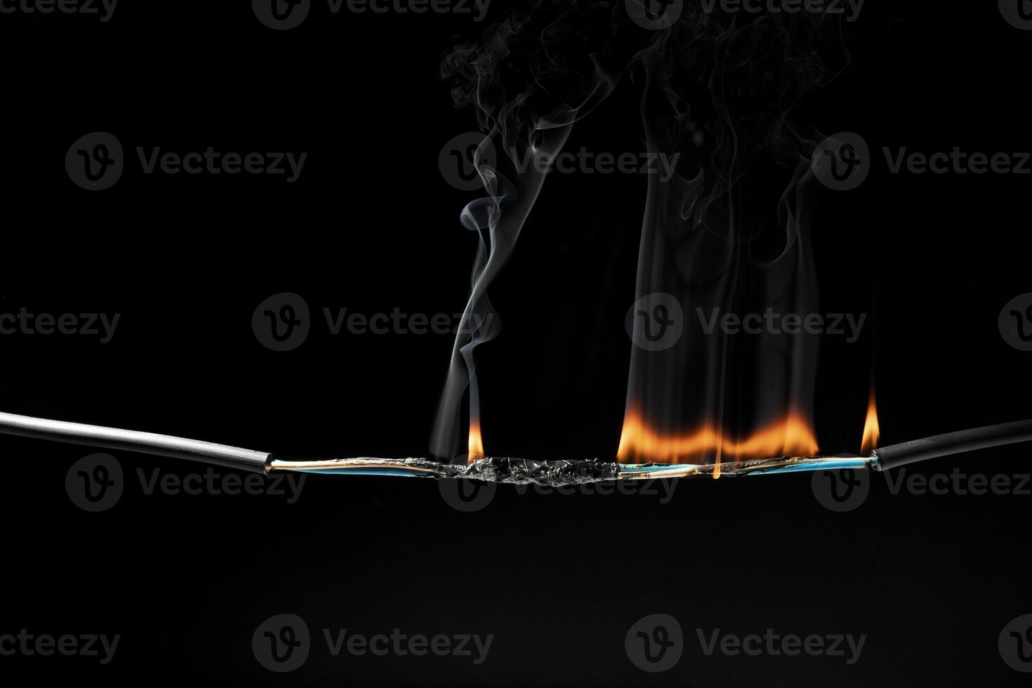 Flames from electric shocks Short-circuited cables cause sparks, explosions, excessive power usage, damaged and non-standard equipment. on a dark black background photo