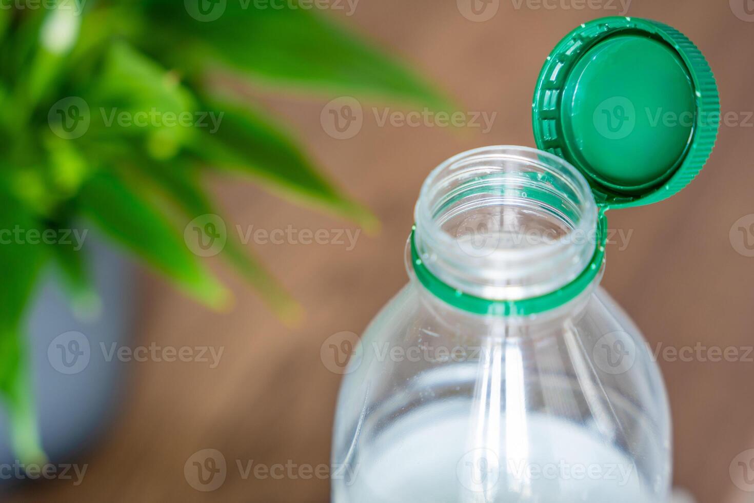Stationary plastic cap on a PET bottle. The new design means the cap remains attached to the bottle after opening, making the entire package easier to collect and recycle. High quality photo