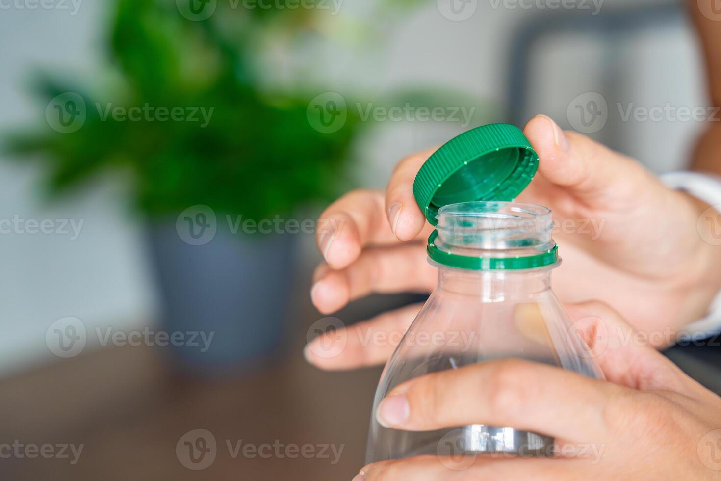 Stationary plastic cap on a PET bottle. The new design means the cap remains attached to the bottle after opening, making the entire package easier to collect and recycle. High quality photo