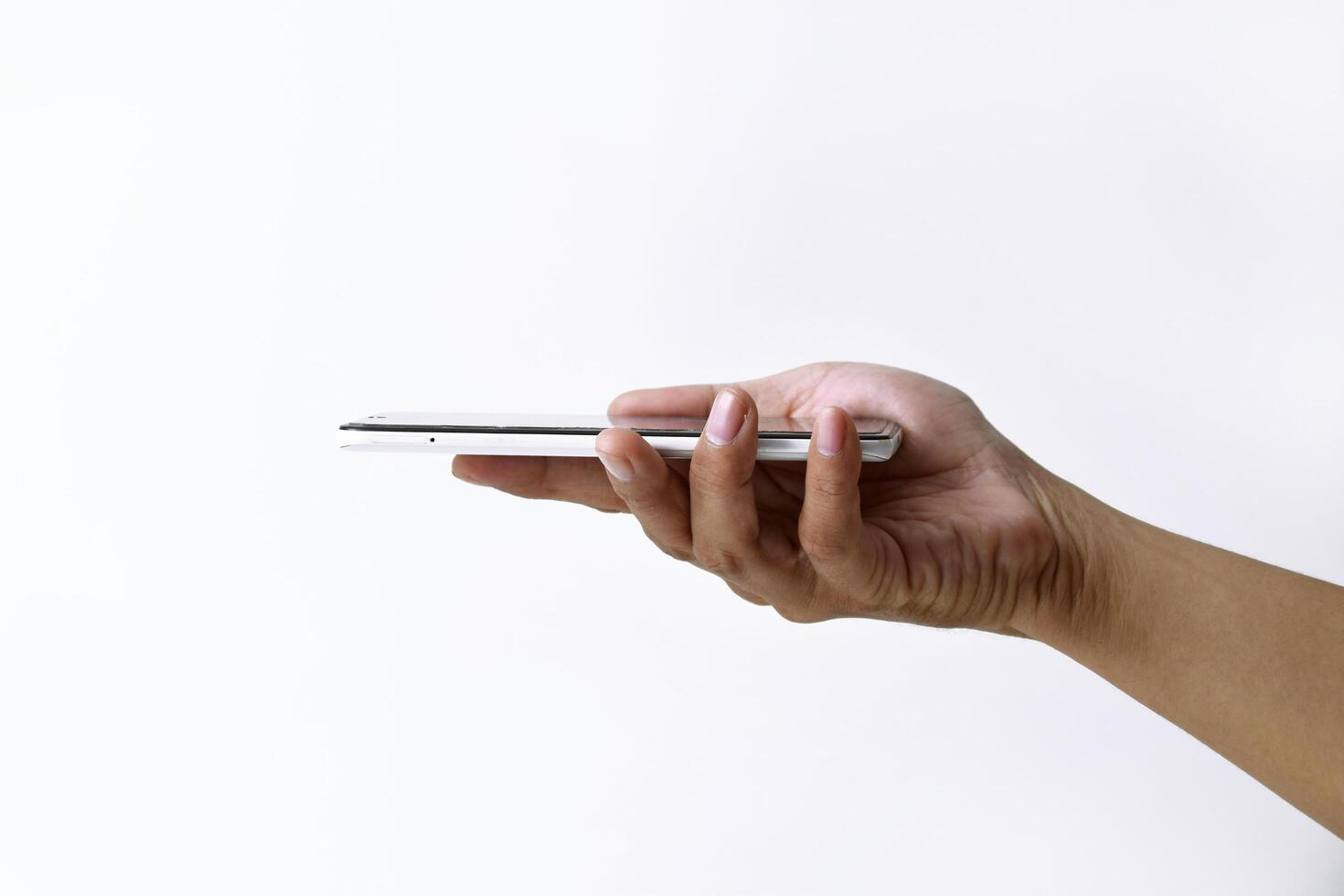 Male hand shows the screen of a smart phone which has a white screen photo