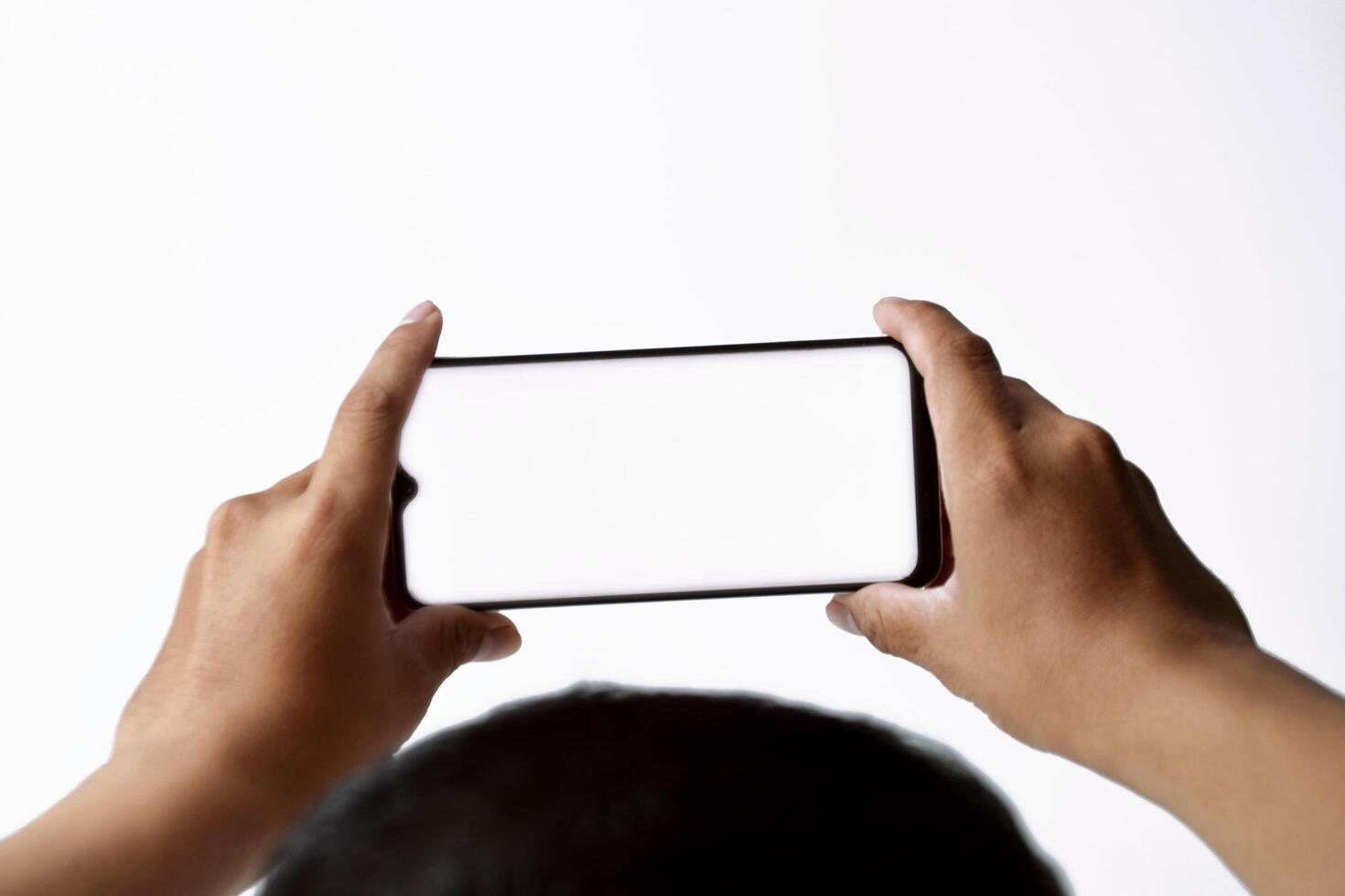 A mans and his hands are using and looking at a mobile smartphone photo