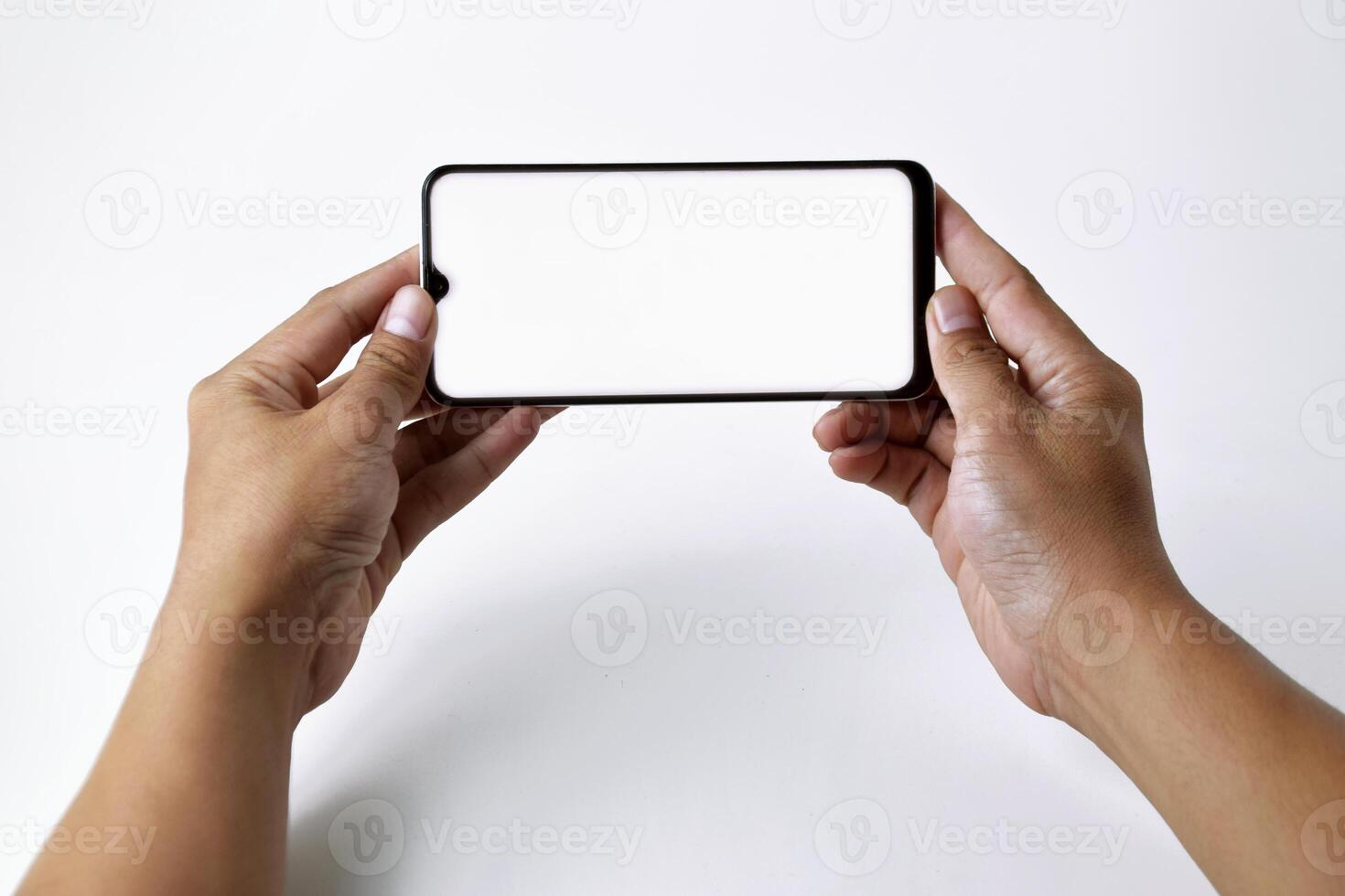 Male hand shows the screen of a mobile smartphone which has a white screen photo