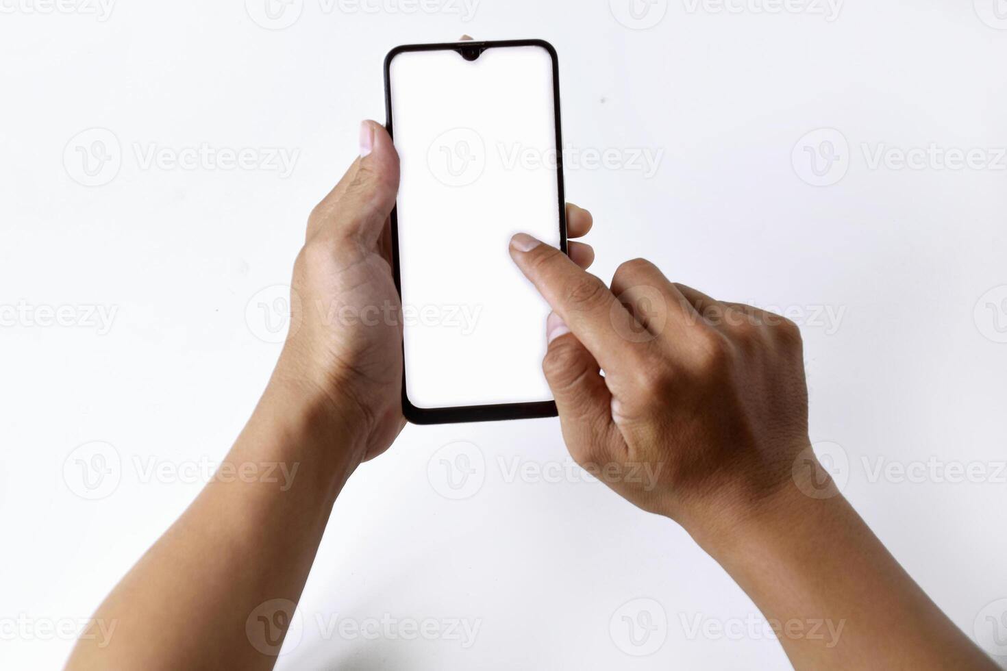 A man's hand is playing with a mobile smartphone with a white screen photo