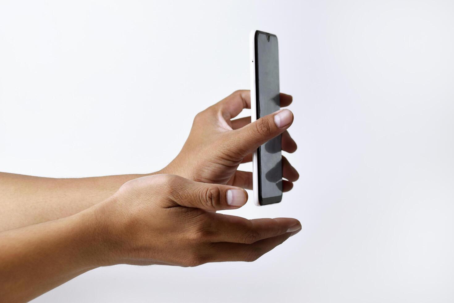 Male hand shows the screen of a smart phone which has a white screen photo
