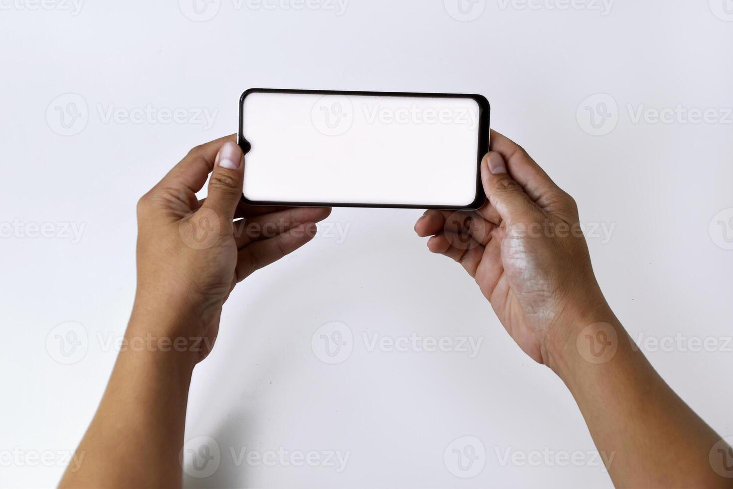 Male hand shows the screen of a mobile smartphone which has a white screen photo