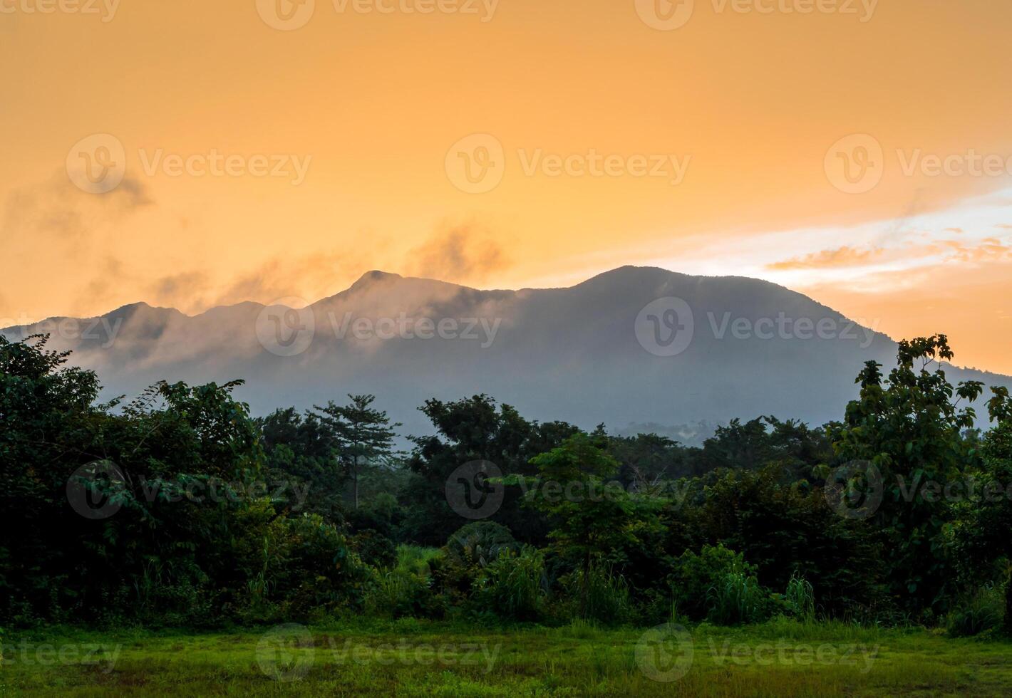 Colorful Sky and Clouds drifting over the forest mountain in evening time photo