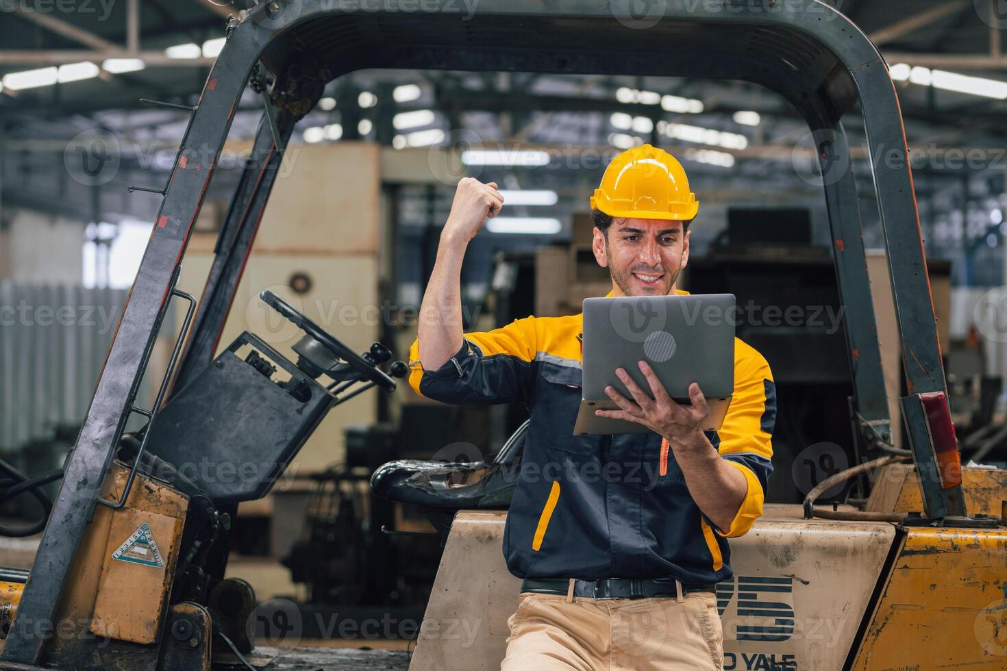 Caucasian engineer using a laptop in a factory. man working in plastics factory. photo
