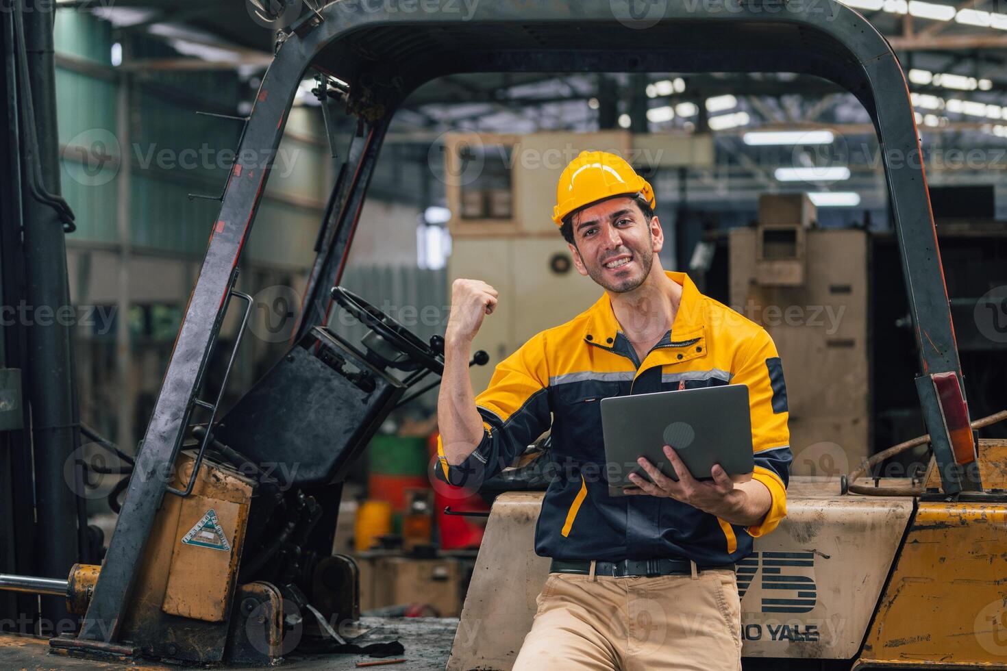 Caucasian engineer using a laptop in a factory. man working in plastics factory. photo