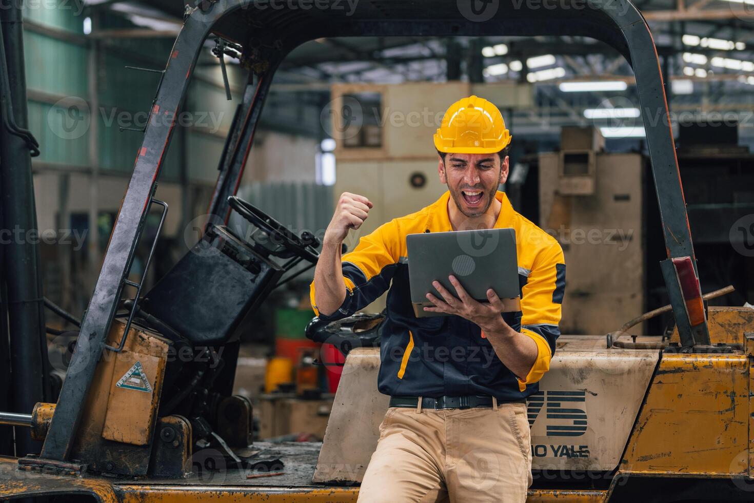 Caucasian engineer using a laptop in a factory. man working in plastics factory. photo