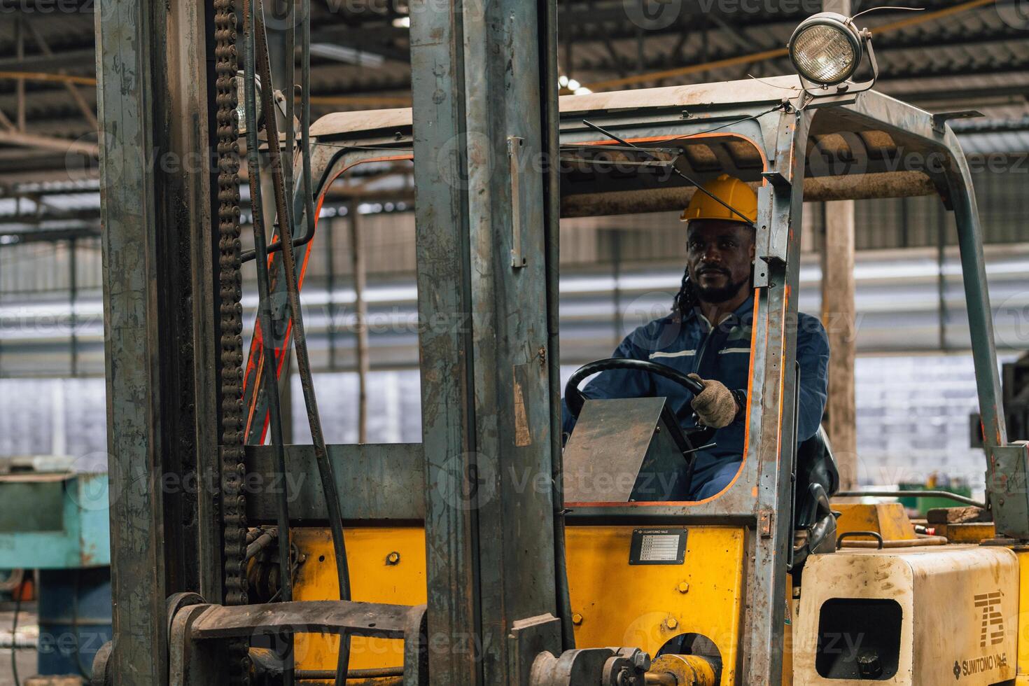 Industrial worker indoors in old factory. Industrial man Engineers in Hard Hats.Work at the Heavy Industry Manufacturing Factory. photo