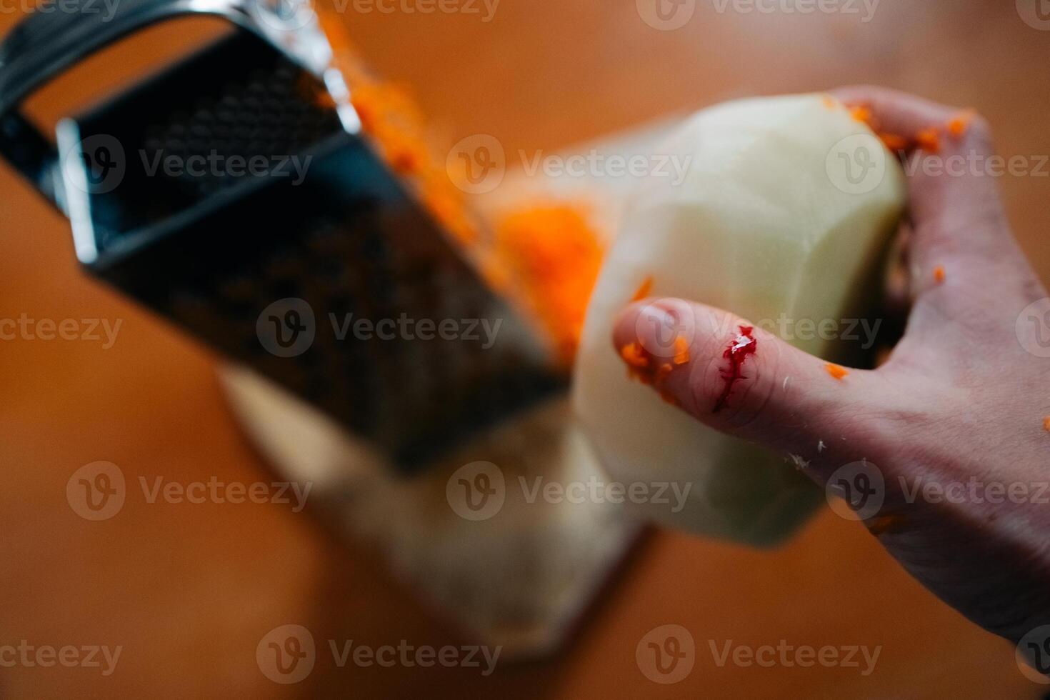 woman cuts her finger while preparing salad for dinner photo