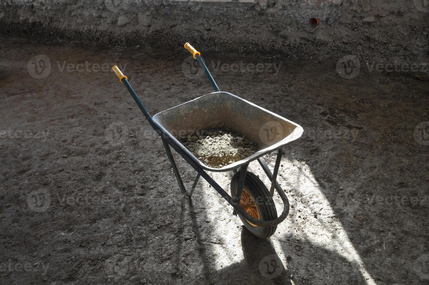 wheelbarrow in building site aka construction site photo