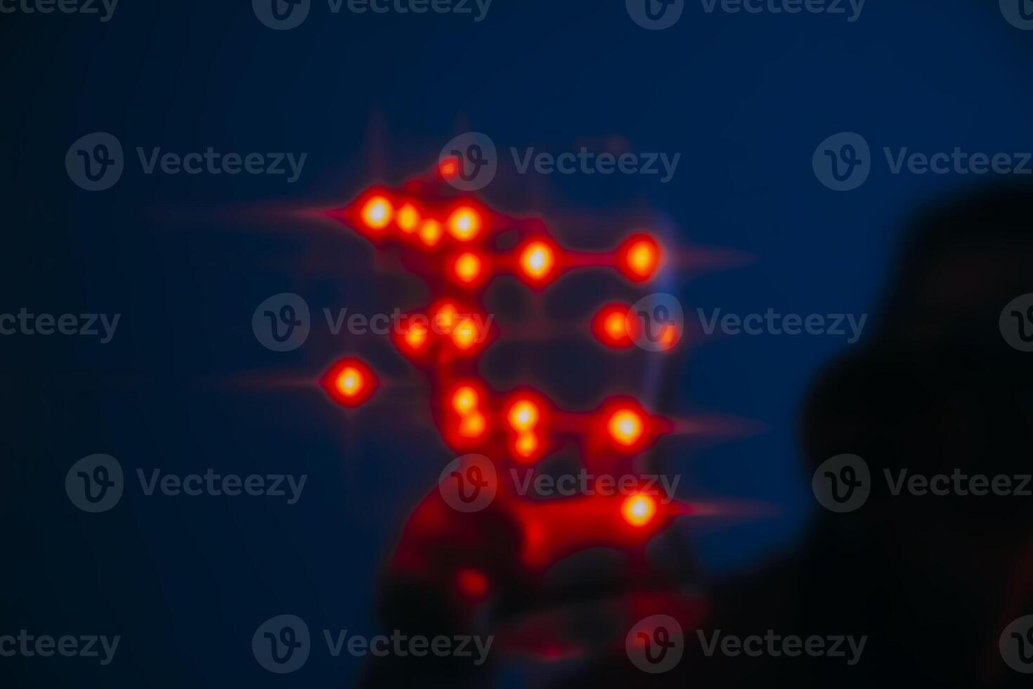 Human unrecognizable silhouette with shiny lights in a dark room photo