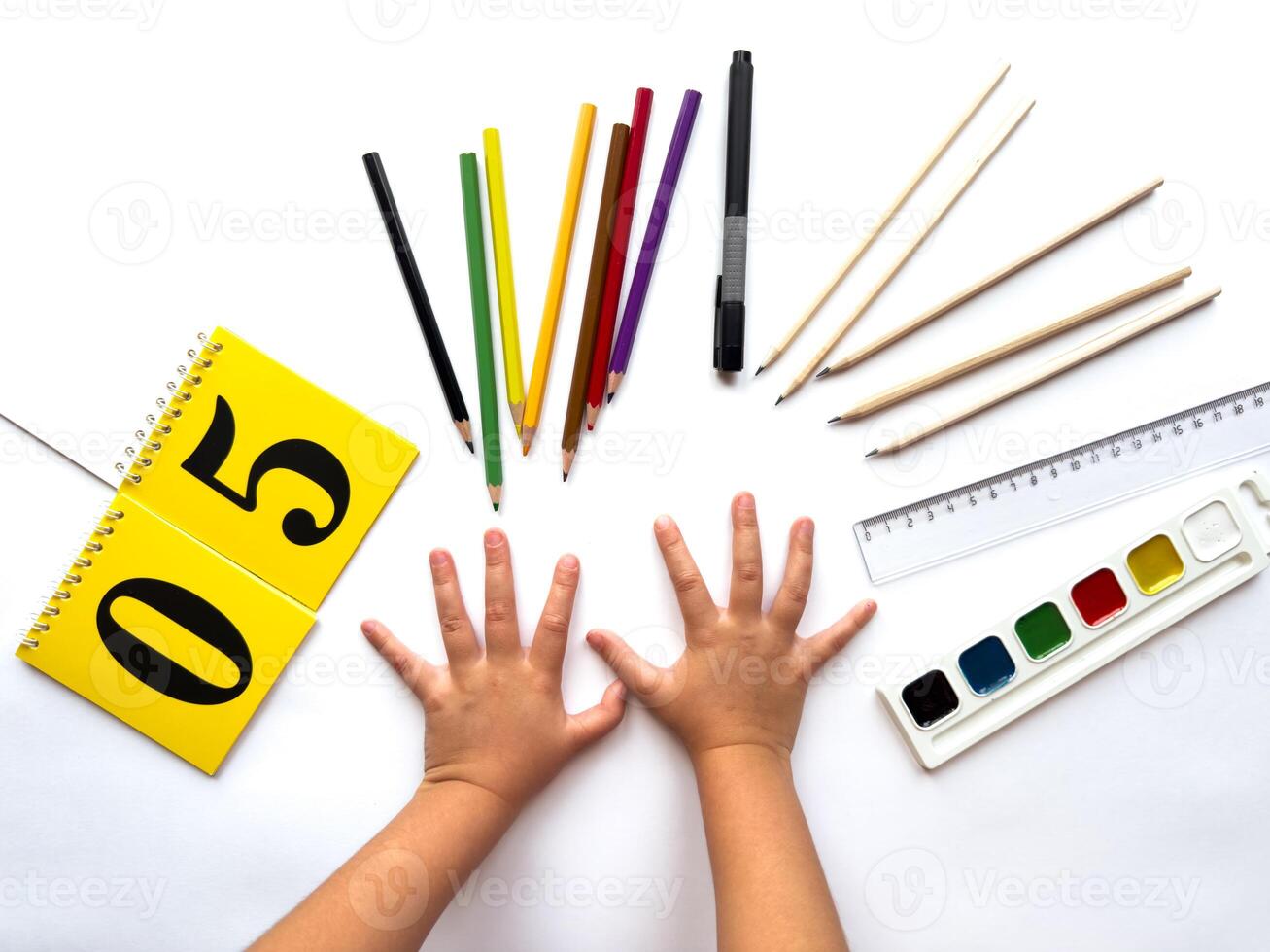 Creative learning. Childs hands with art supplies and calendar photo