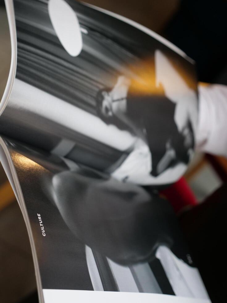 A person is holding a book with a photo of a person