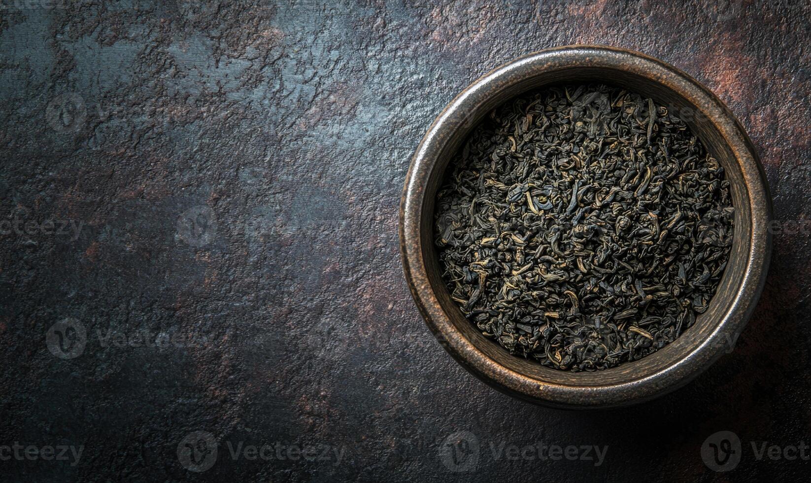 A bowl of black tea leaves photo