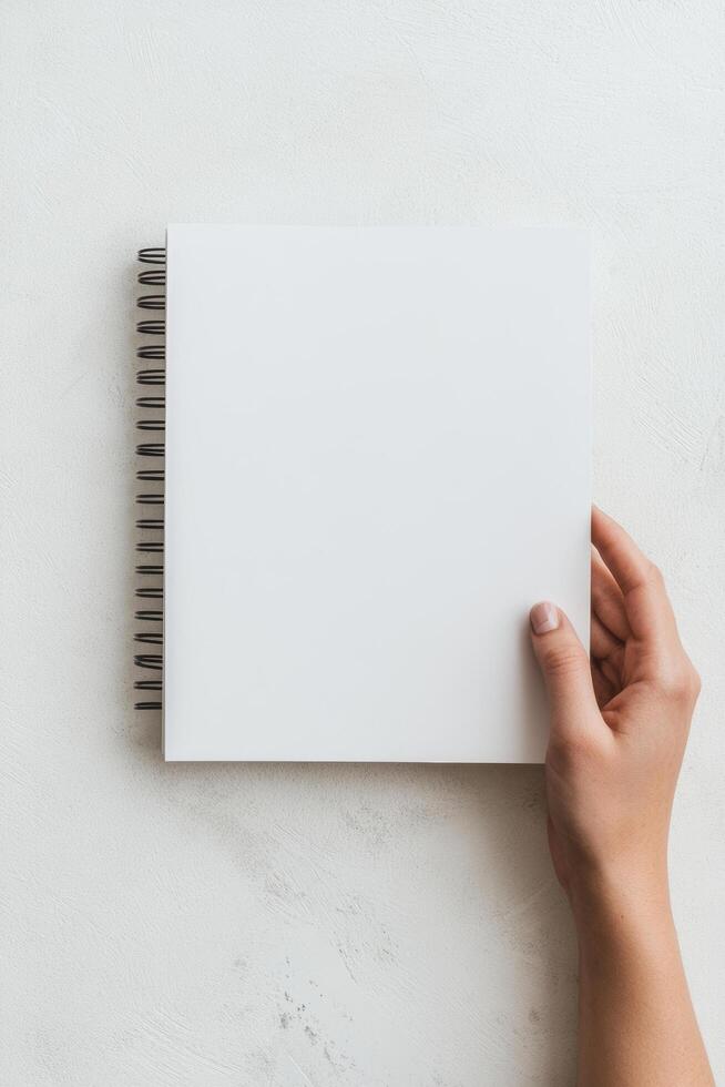 blank sketchbook held by hand, perfect for artists and creatives to express their ideas. This image captures essence of creativity and inspiration photo