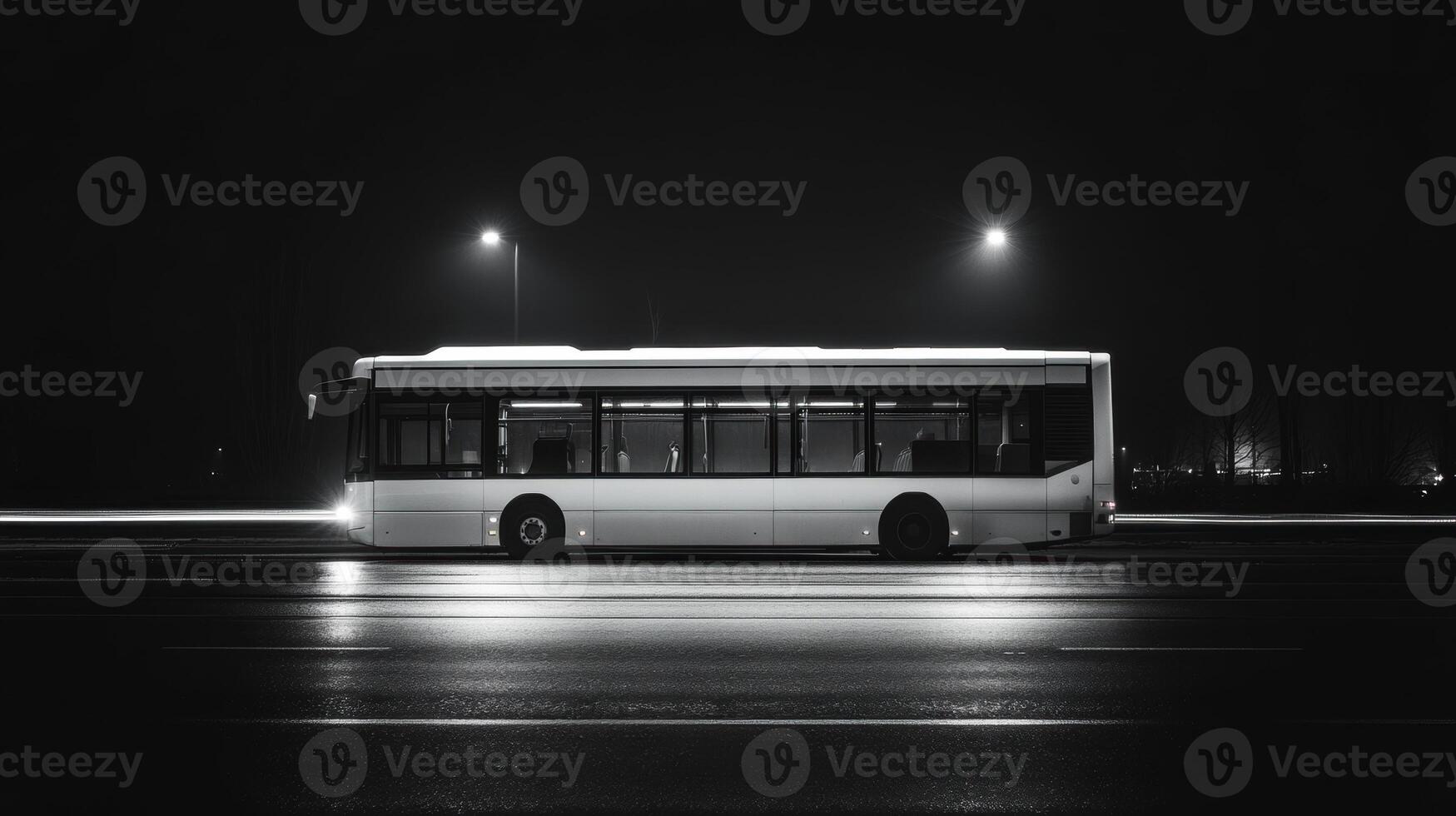 white bus stands still on dark road, illuminated by streetlights, creating striking contrast against night sky photo