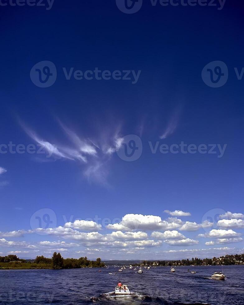 Serene Lake Landscape with Cumulus Clouds and Watercraft Activities photo