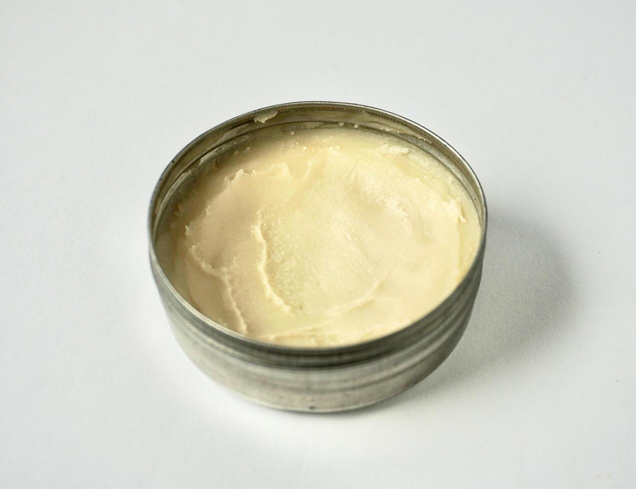 Deodorant cream skin care product inside round metal tin jar container isolated on horizontal ratio background. photo