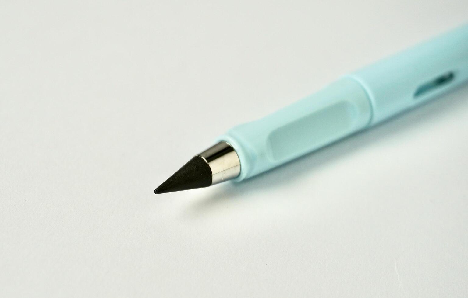 One blue stationary eternal graphite pencil object photography isolated on horizontal white background. photo