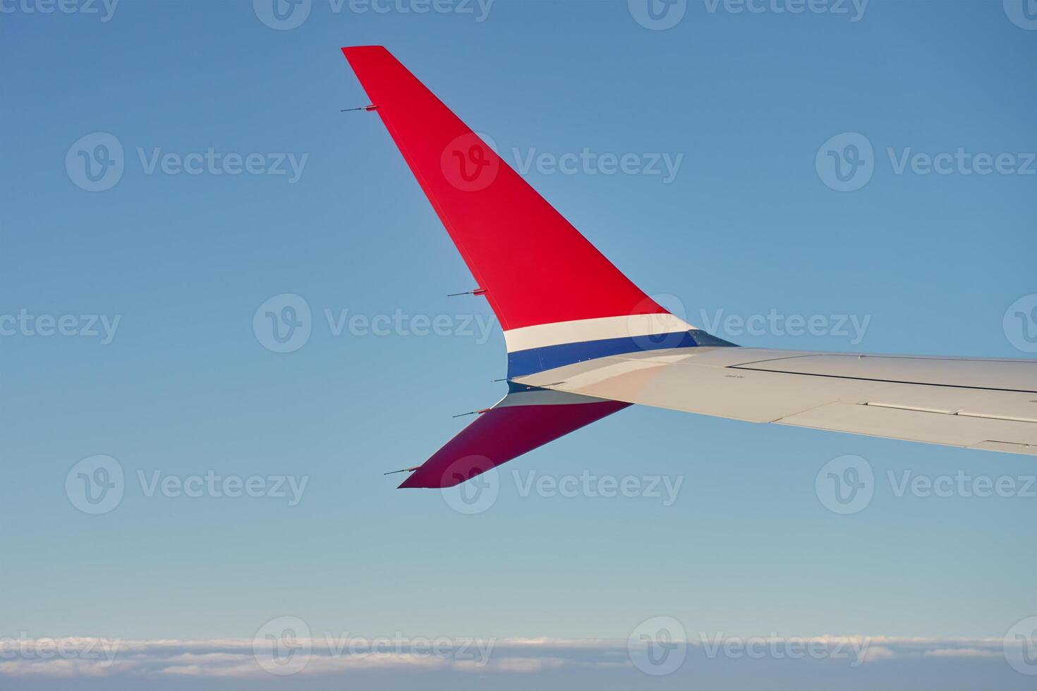 View of airplane wing from an airplane window. Air travel and flight concept photo