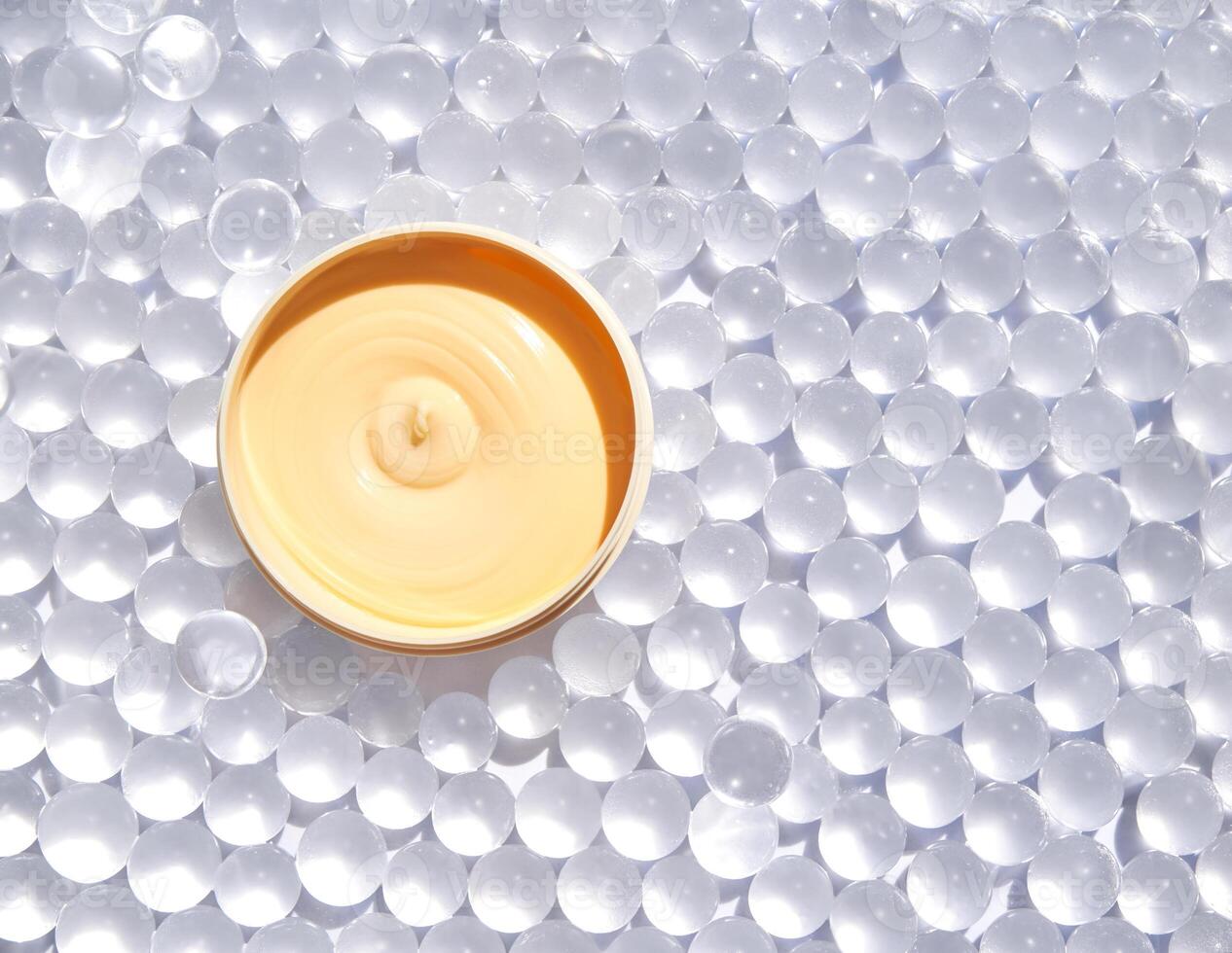 Luxurious skin moisturizer on clear gel beads for enhanced hydration and skincare beauty in natural sunlight. photo