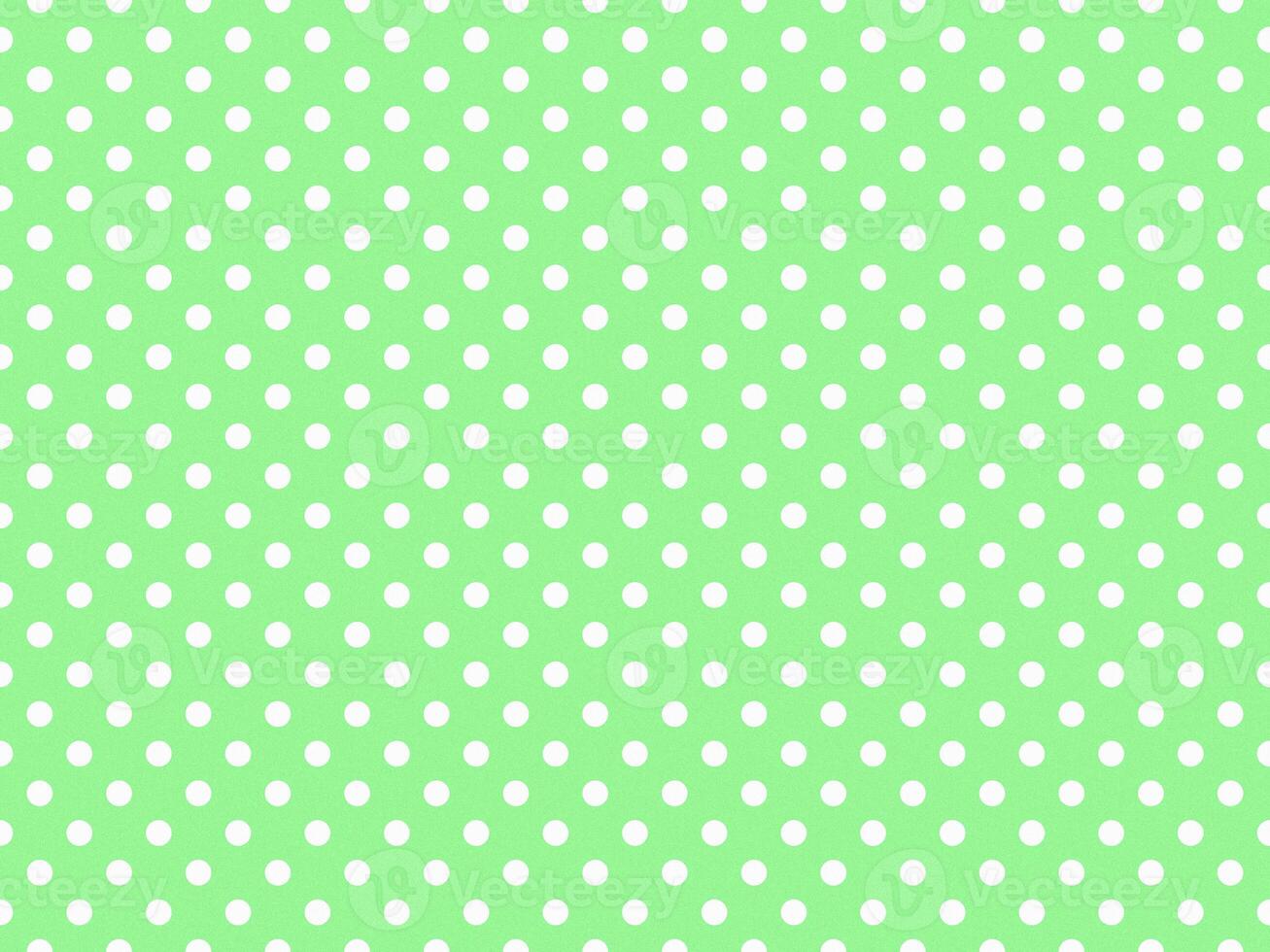 texturised white color polka dots over pale green background photo