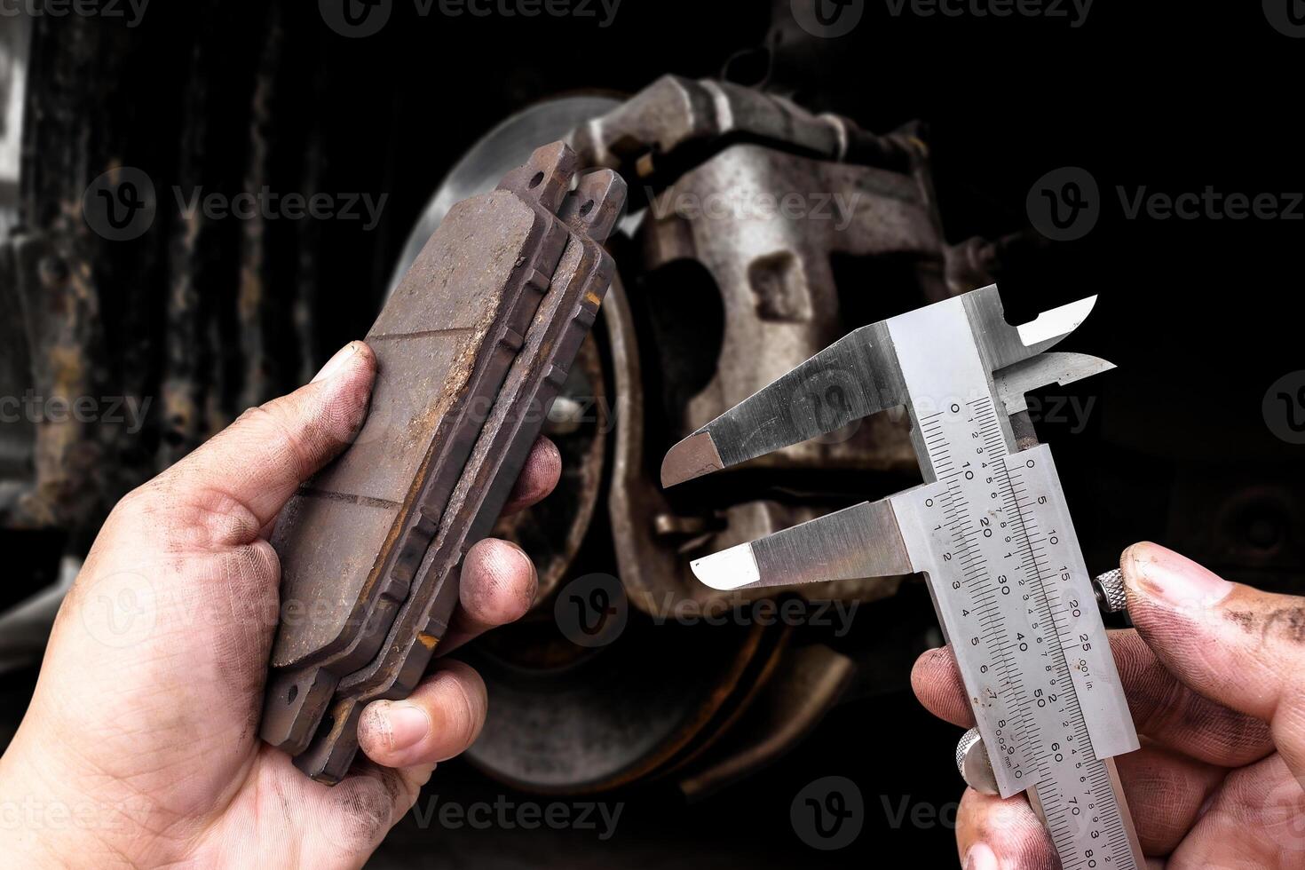 Precision measurement of brake pad with vernier caliper by auto mechanic , Car maintenance concept photo