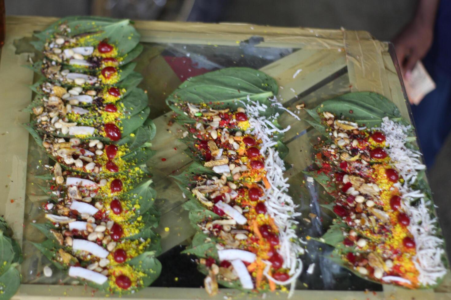 Banarasi paan or betel leaf garnished with betel nut and all indian colorful banarasi ingredients for sale at pous fair,santiniketan photo