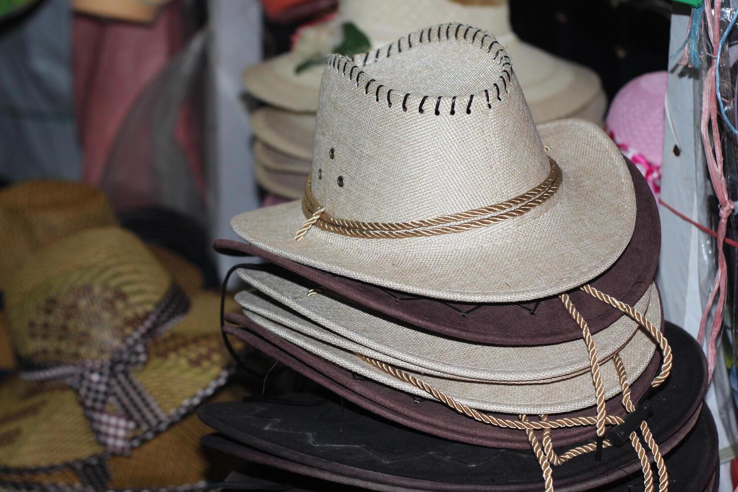 Straw hats for men sold in the shop. interior. Men's winter hats.Typical ecuadorian hats from the sierra in different colours photo