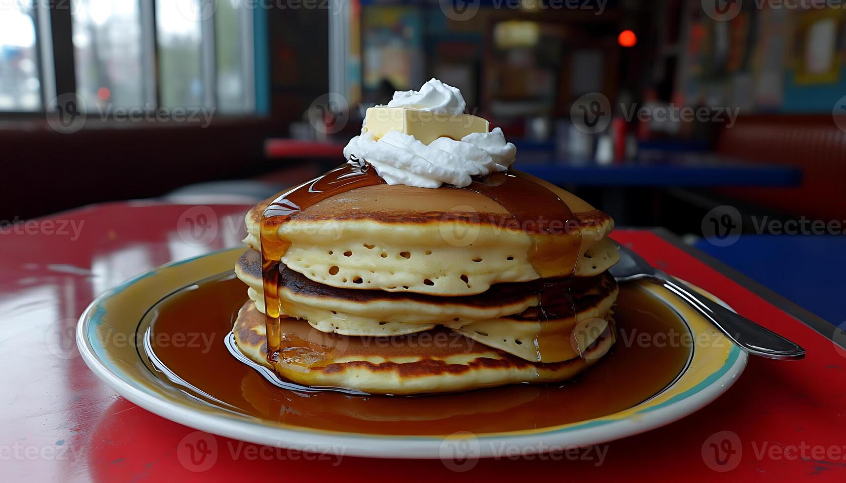 Delicious stacked pancakes topped with butter and whipped cream photo