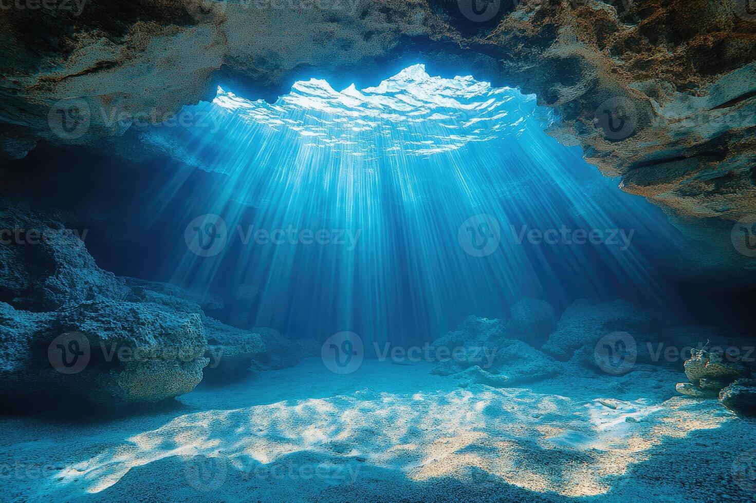 Sunlight illuminating underwater cave with rippled surface photo