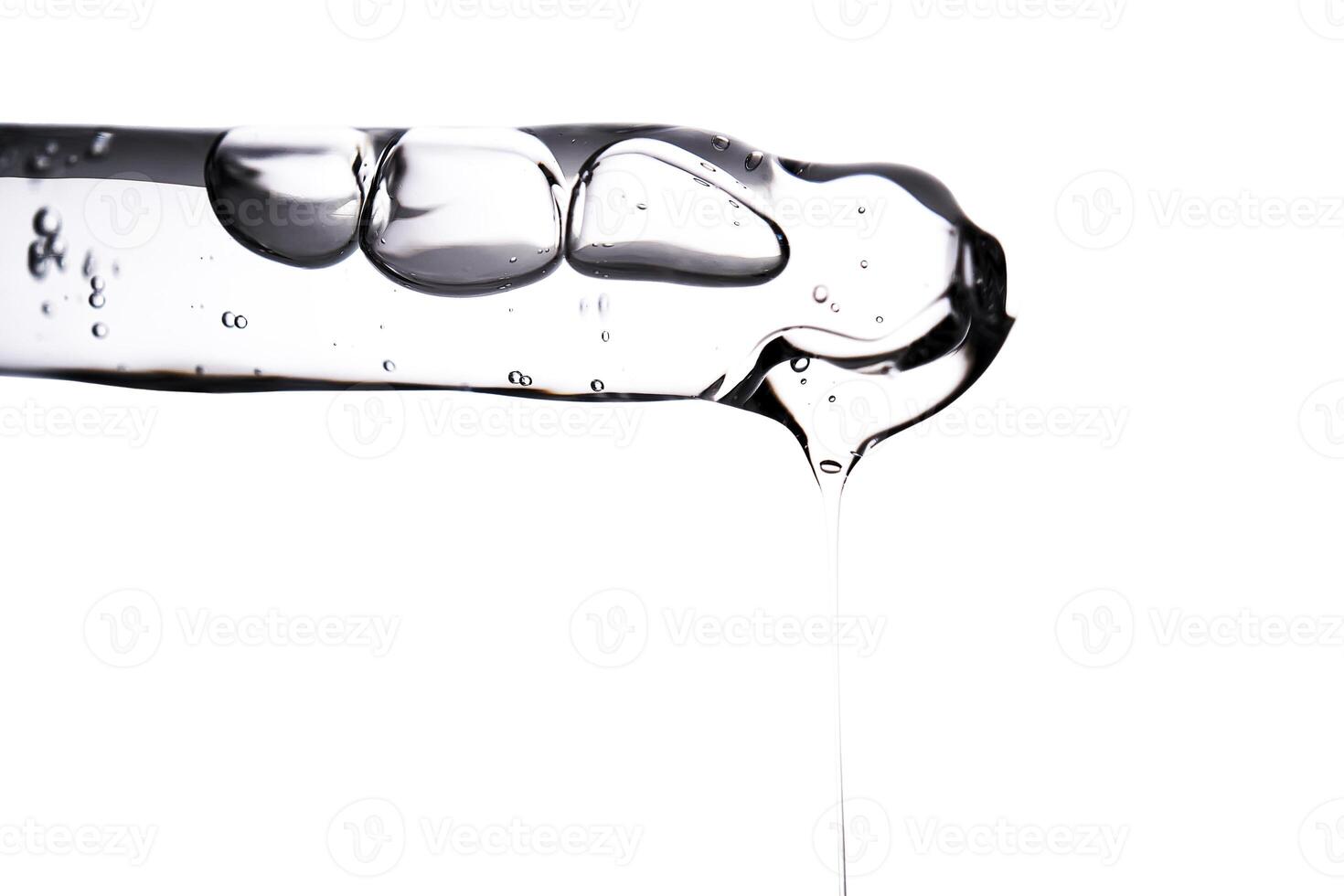 Dropper pipette with delicious serum with bubbles close-up. photo