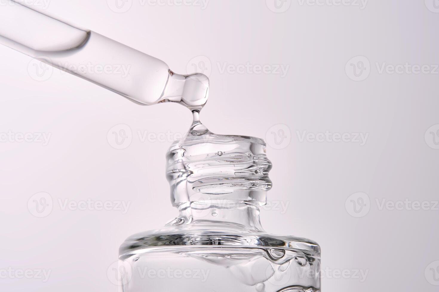 Close-up of a cosmetic bottle with a pipette showing the texture of the serum. photo