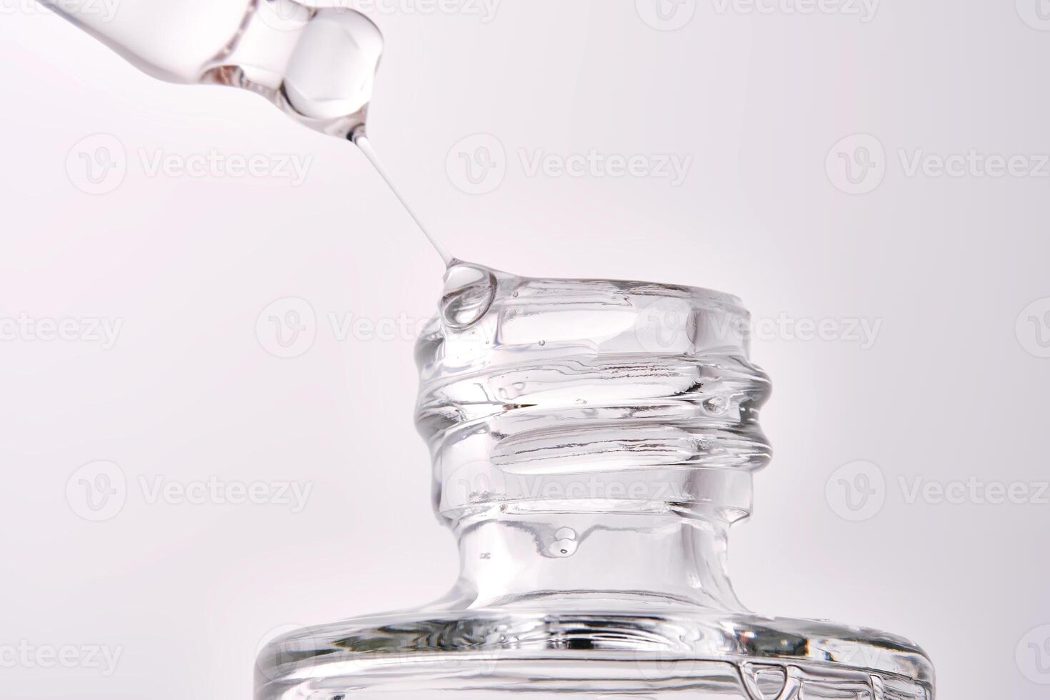 Close-up of a cosmetic bottle with a pipette showing the texture of the serum. photo