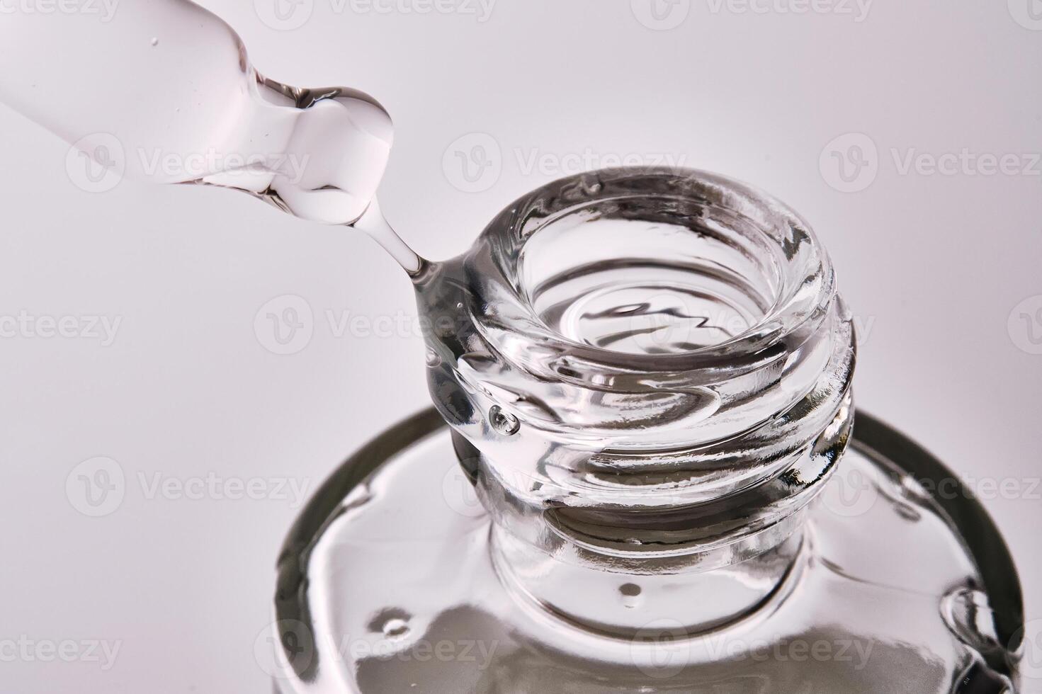Close-up of a cosmetic bottle with a pipette showing the texture of the serum. photo