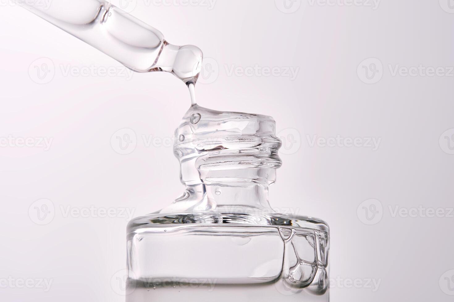 Close-up of a cosmetic bottle with a pipette showing the texture of the serum. photo