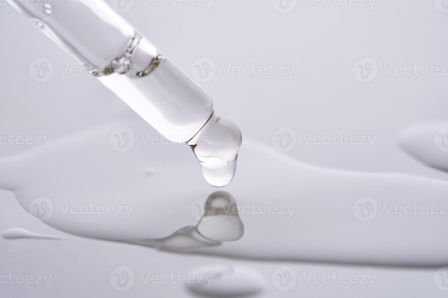 Dropper pipette with delicious serum with drop close-up. photo