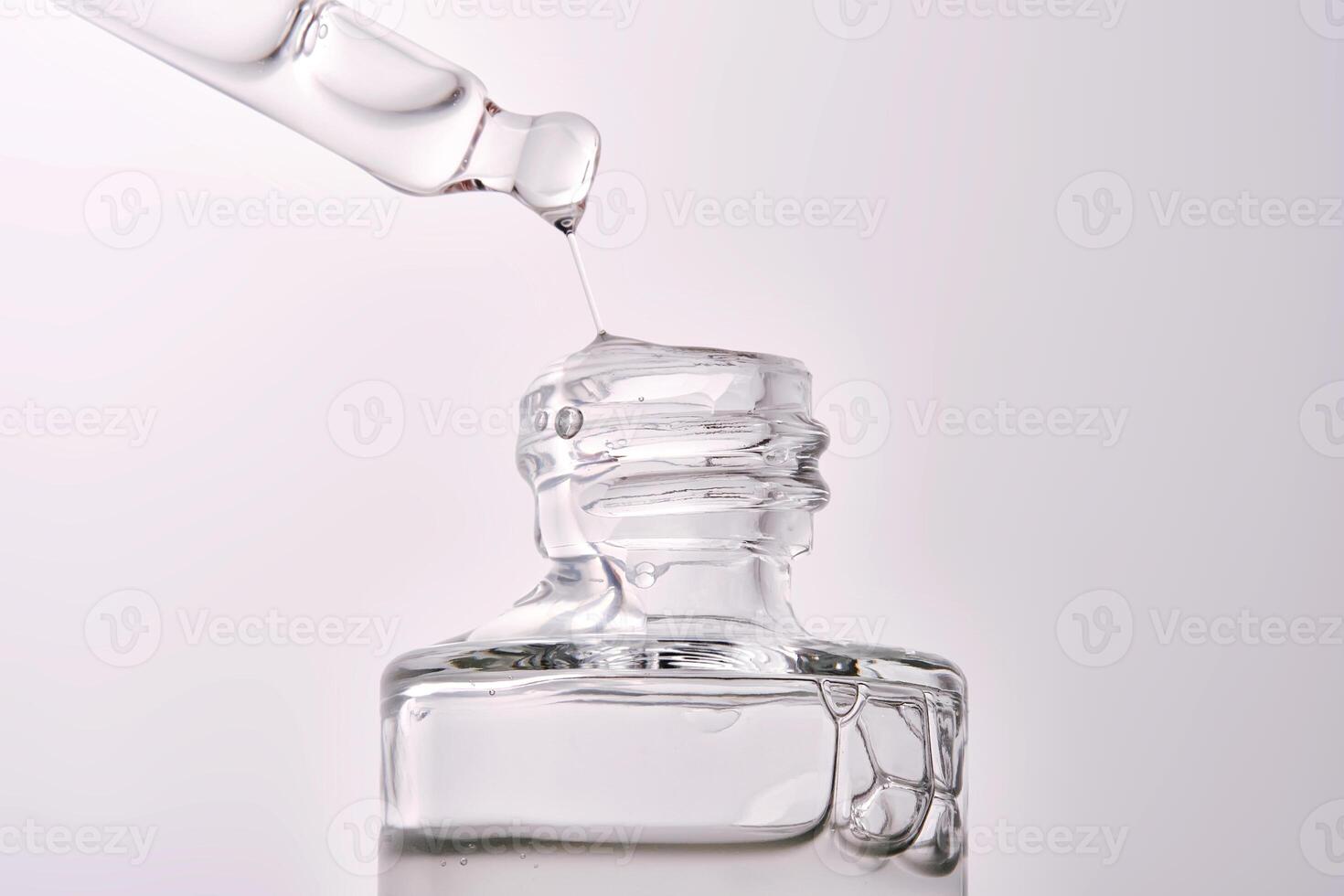 Close-up of a cosmetic bottle with a pipette showing the texture of the serum. photo